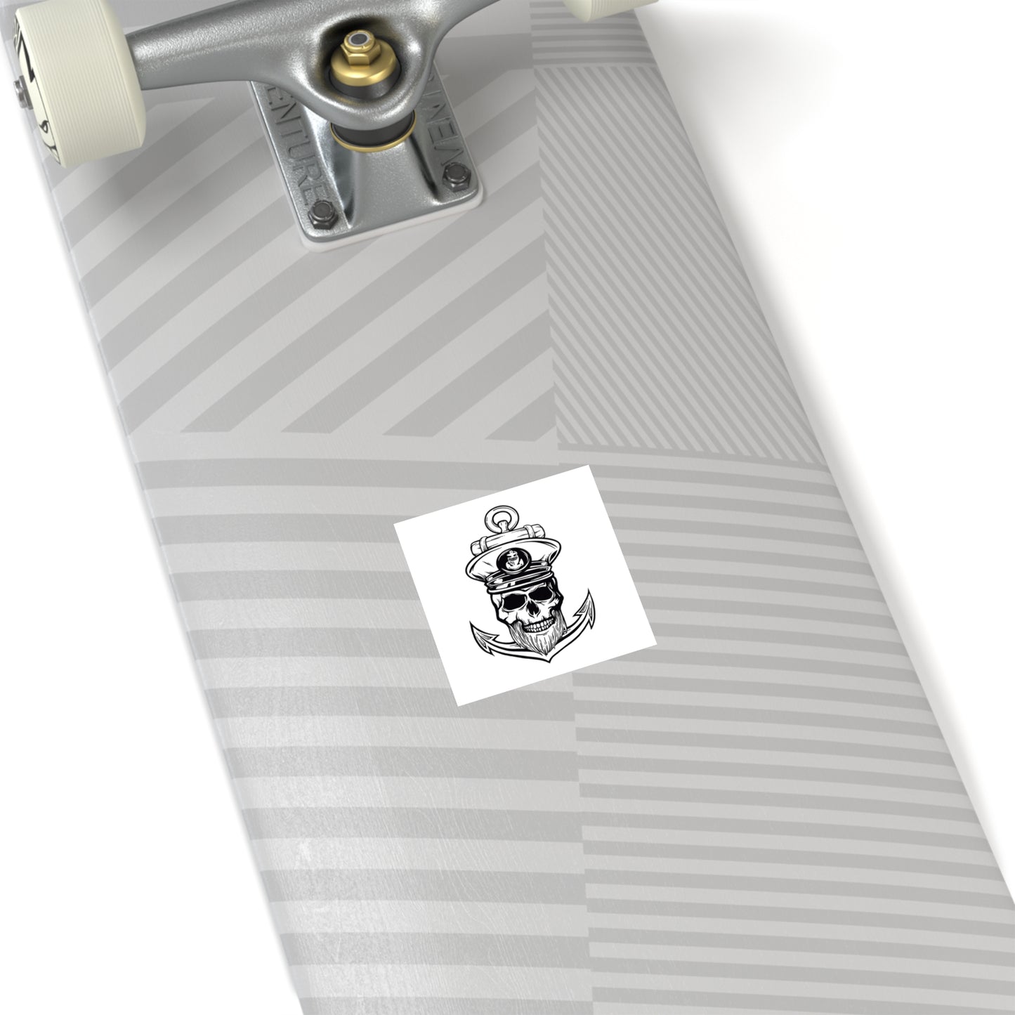 The underside of a skateboard with sticker featuring a Black and white illustration of a skull with a captain's hat, a beard, with an anchor behind it