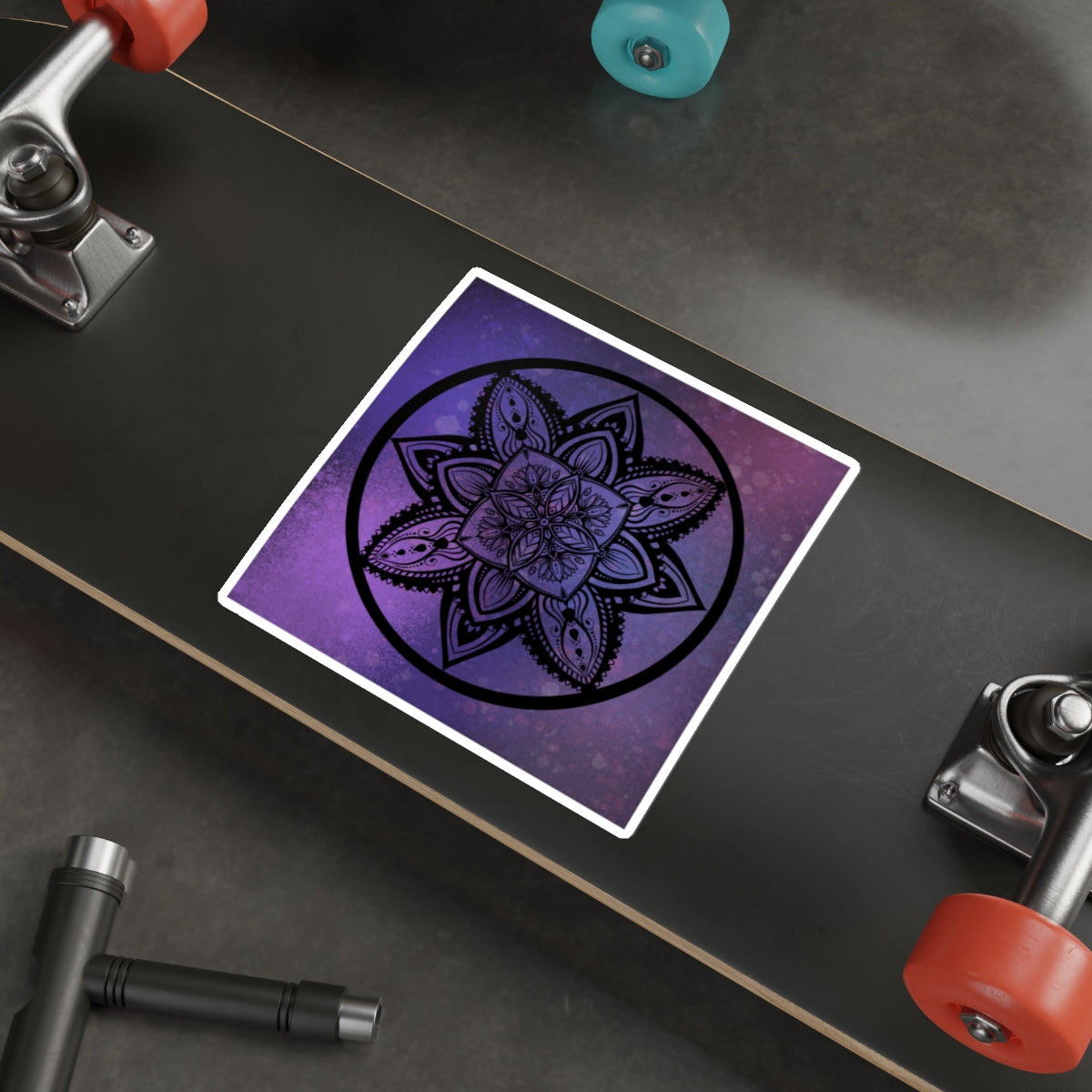 Purple mandala sticker on a skateboard deck