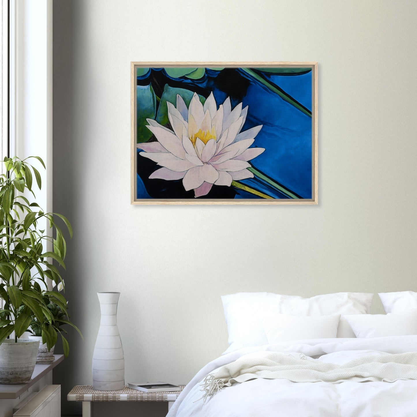 Framed artwork of a water lily on a wall above a bed in a bedroom.